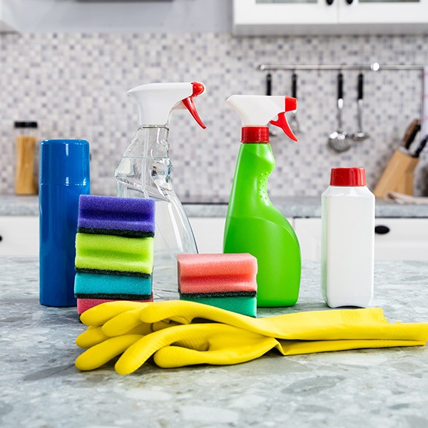 Cleaning Supplies And Yellow Handgloves On The Kitchen Countertop | Stonemeyer Granite