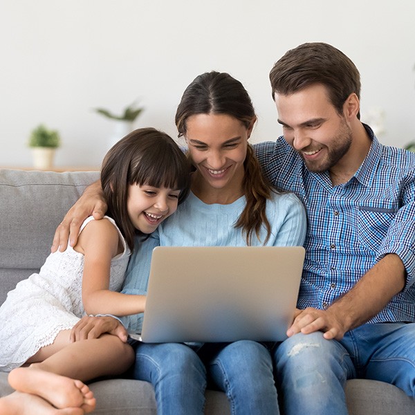 Happy family with kid girl having fun using laptop together | Stonemeyer Granite